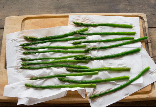 A idéia de um almoço de verão: torradas com salmão e uma salada de espargos quentes